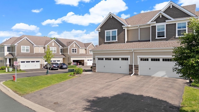 6980 Archer Trl, Inver Grove Heights, MN 55077 - view of front of house with driveway, a garage, stone siding, a residential view, and roof with shingles