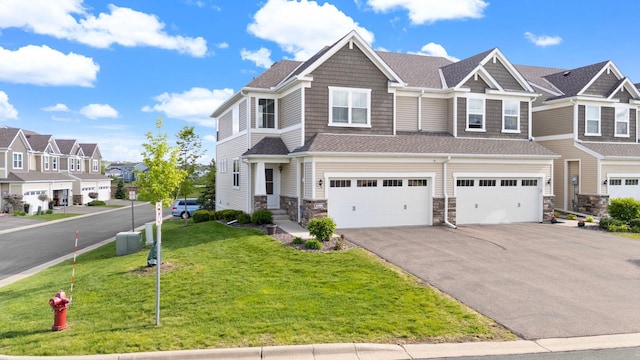 6980 Archer Trl, Inver Grove Heights, MN 55077 - townhome / multi-family property featuring asphalt driveway, an attached garage, a residential view, a front yard, and stone siding
