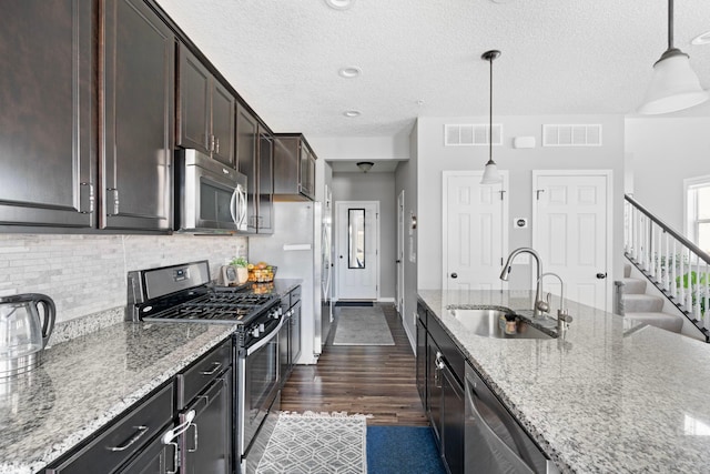 6980 Archer Trl, Inver Grove Heights, MN 55077 - kitchen with stainless steel appliances, a sink, backsplash, dark wood-style flooring, and dark brown cabinetry