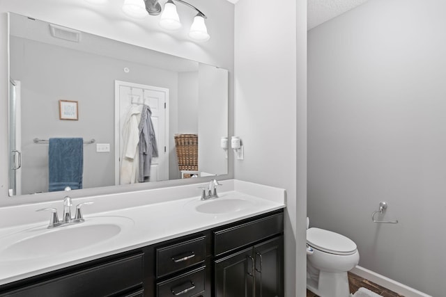 6980 Archer Trl, Inver Grove Heights, MN 55077 - full bath featuring toilet, double vanity, wood finished floors, and a textured ceiling
