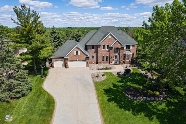 3877 Fairway Dr, Woodbury, MN 55125 - view of front of home with brick siding, concrete driveway, a garage, and a front yard