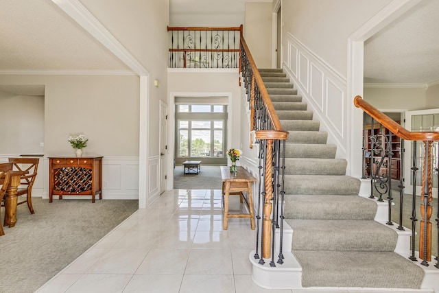 3877 Fairway Dr, Woodbury, MN 55125 - entrance foyer with stairway, ornamental molding, light colored carpet, a towering ceiling, and light tile patterned floors