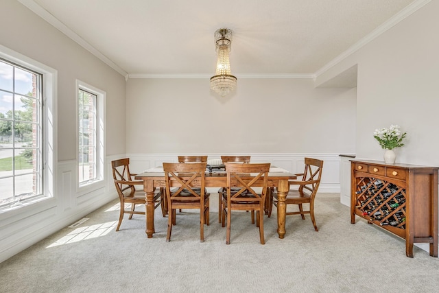 3877 Fairway Dr, Woodbury, MN 55125 - dining space with light carpet, crown molding, a wainscoted wall, and a chandelier