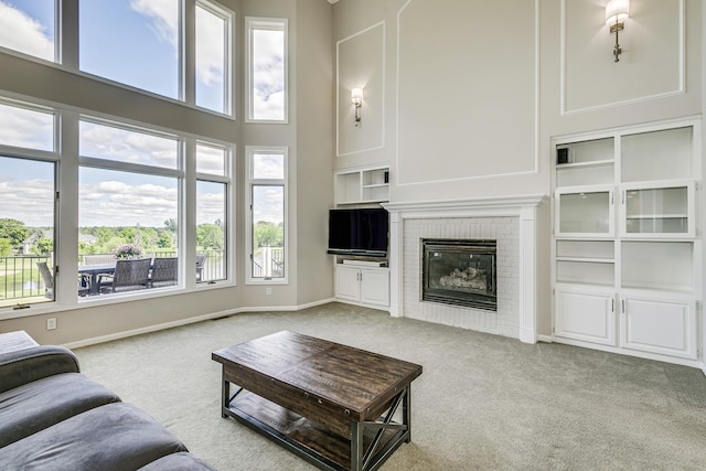 3877 Fairway Dr, Woodbury, MN 55125 - living room with light carpet, plenty of natural light, a brick fireplace, a towering ceiling, and baseboards