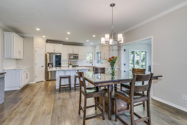 3877 Fairway Dr, Woodbury, MN 55125 - dining space featuring wood finished floors, crown molding, a chandelier, recessed lighting, and baseboards