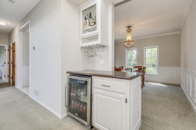 3877 Fairway Dr, Woodbury, MN 55125 - indoor dry bar with wine cooler, light colored carpet, crown molding, and a wainscoted wall