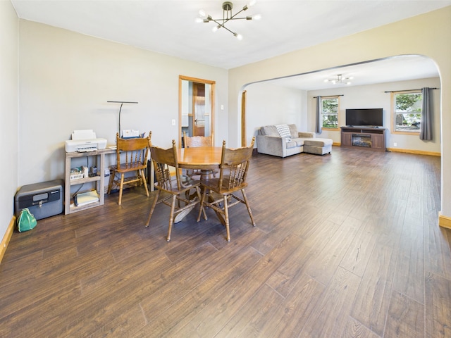 302 2nd St S, Melrose, MN 56352 - dining area with a chandelier, arched walkways, wood finished floors, and baseboards