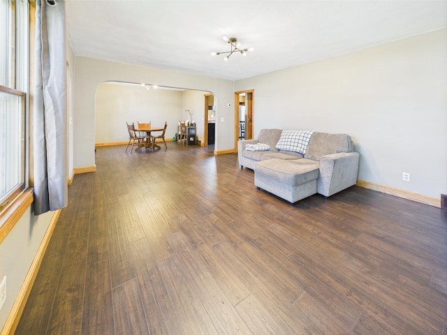 302 2nd St S, Melrose, MN 56352 - living area with arched walkways, wood finished floors, and baseboards