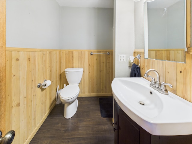 302 2nd St S, Melrose, MN 56352 - bathroom with toilet, wood finished floors, wainscoting, vanity, and wood walls