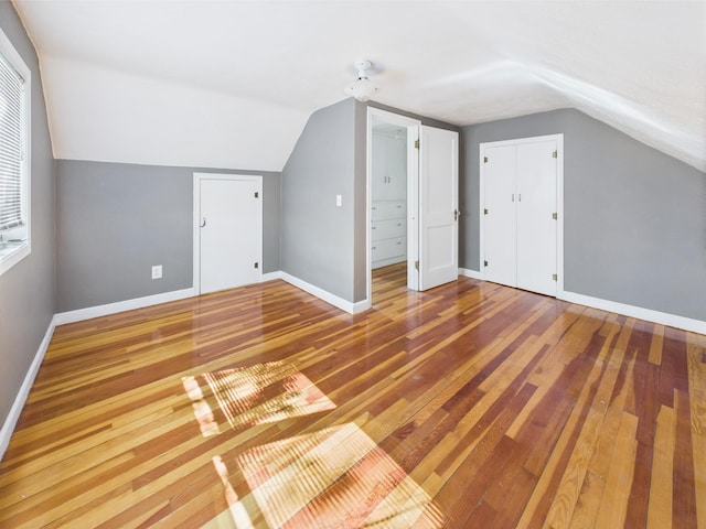 302 2nd St S, Melrose, MN 56352 - bonus room featuring lofted ceiling, wood finished floors, and baseboards