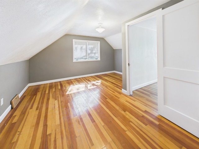 302 2nd St S, Melrose, MN 56352 - bonus room featuring light wood finished floors, lofted ceiling, and baseboards
