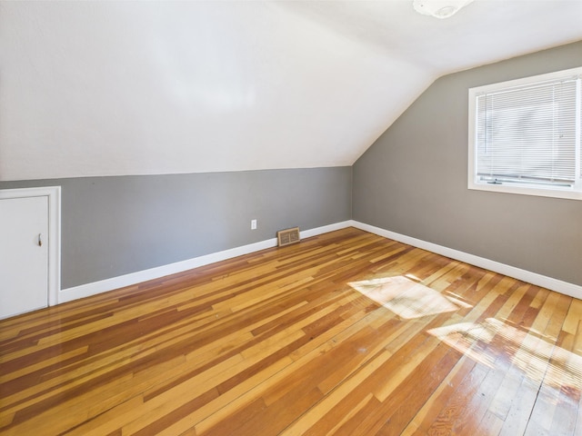 302 2nd St S, Melrose, MN 56352 - additional living space featuring lofted ceiling, hardwood / wood-style floors, and baseboards
