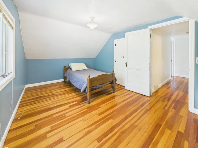 302 2nd St S, Melrose, MN 56352 - bedroom with light wood-type flooring, lofted ceiling, and baseboards