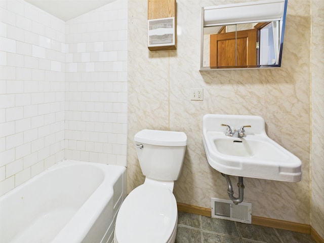 302 2nd St S, Melrose, MN 56352 - bathroom featuring toilet, a tub to relax in, baseboards, and a sink