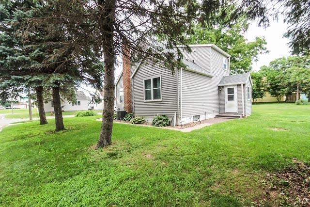 302 2nd St S, Melrose, MN 56352 - view of grassy yard with central AC unit and entry steps