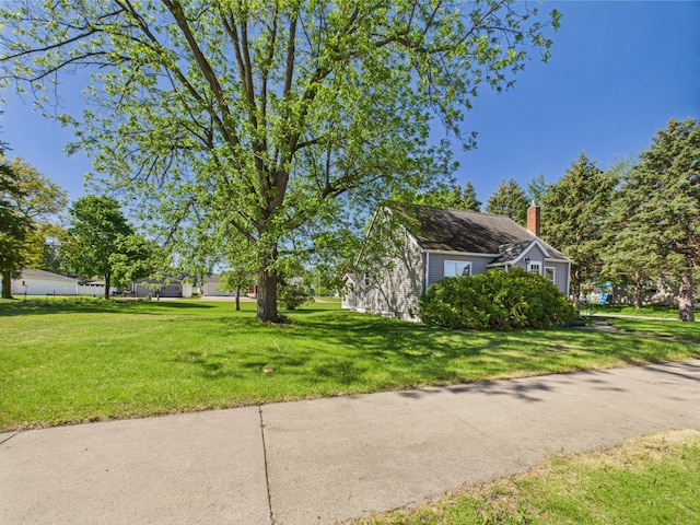302 2nd St S, Melrose, MN 56352 - view of property exterior featuring a chimney and a lawn