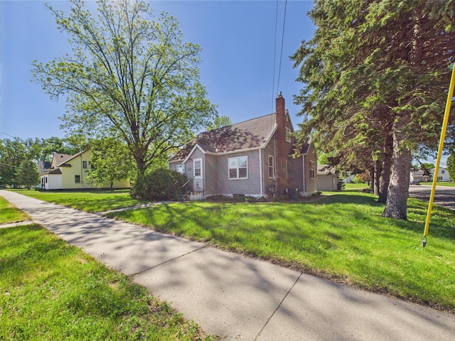 302 2nd St S, Melrose, MN 56352 - view of front facade featuring a chimney, a front yard, and central AC
