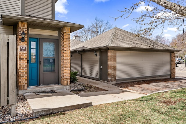 445 Shelard Pkwy Unit 204, Saint Louis Park, MN 55426 - doorway to property with brick siding and roof with shingles