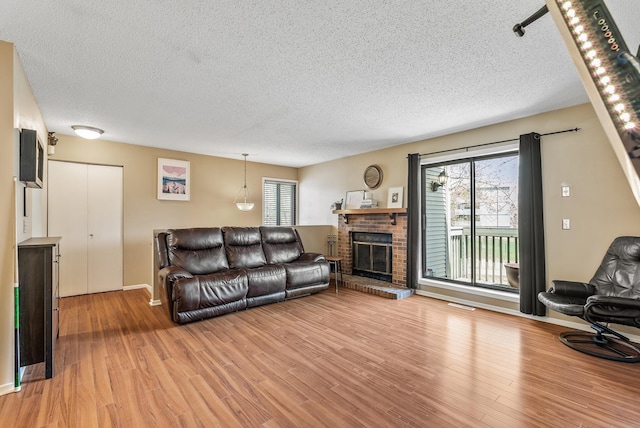 445 Shelard Pkwy Unit 204, Saint Louis Park, MN 55426 - living area with a textured ceiling, healthy amount of natural light, light wood finished floors, and a fireplace
