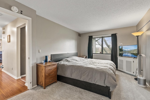 445 Shelard Pkwy Unit 204, Saint Louis Park, MN 55426 - bedroom featuring a textured ceiling, light carpet, and baseboards