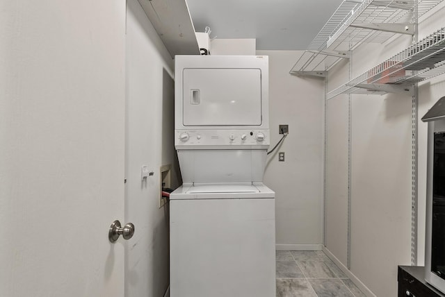 445 Shelard Pkwy Unit 204, Saint Louis Park, MN 55426 - washroom featuring stacked washer / dryer and baseboards