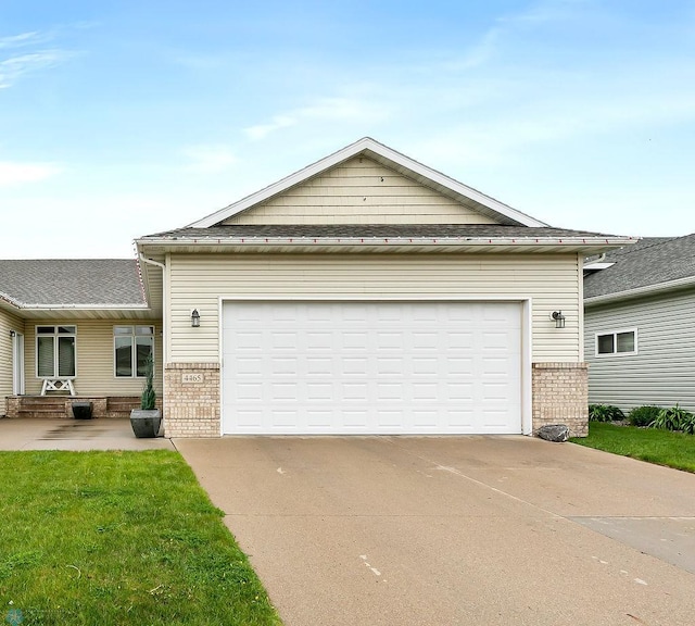 4465 53rd St S, Fargo, ND 58104 - view of front of home with brick siding, driveway, and a front yard