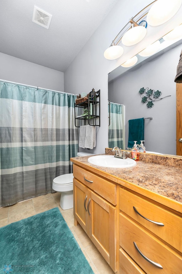 4465 53rd St S, Fargo, ND 58104 - full bathroom featuring vanity, toilet, tile patterned floors, and curtained shower