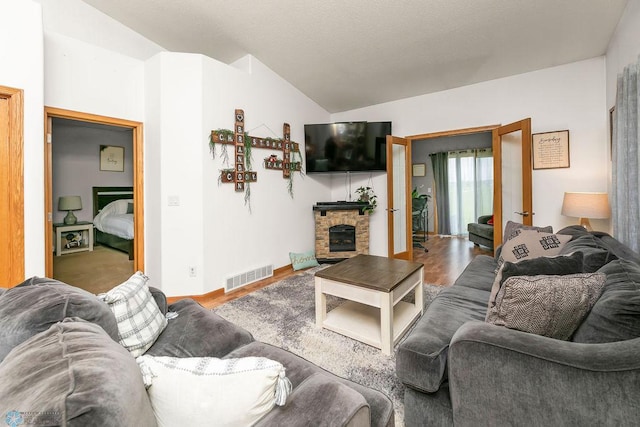 4465 53rd St S, Fargo, ND 58104 - living area featuring vaulted ceiling, a fireplace, wood finished floors, and baseboards
