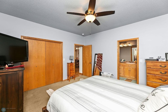 4465 53rd St S, Fargo, ND 58104 - bedroom featuring a closet, light colored carpet, a textured ceiling, a ceiling fan, and connected bathroom