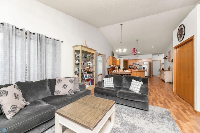 4465 53rd St S, Fargo, ND 58104 - living room with light wood finished floors, a chandelier, and lofted ceiling