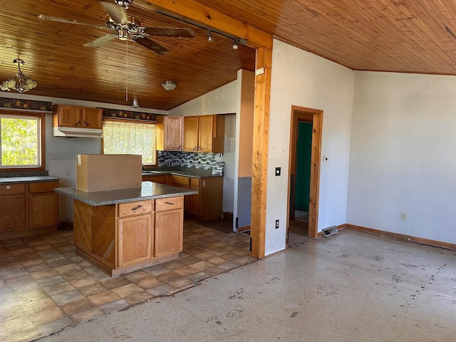 28 Cypress Blvd, Babbitt, MN 55706 - kitchen featuring under cabinet range hood, wooden ceiling, healthy amount of natural light, vaulted ceiling, and dark countertops
