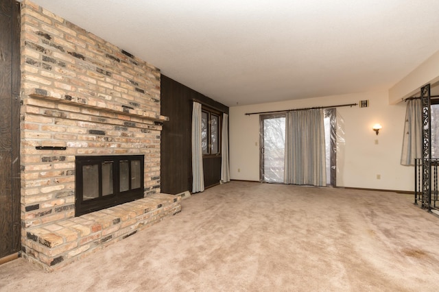 6950 270th St, New Prague, MN 56071 - unfurnished living room with a brick fireplace, carpet, and baseboards