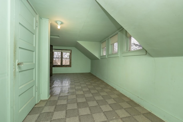 6950 270th St, New Prague, MN 56071 - additional living space featuring vaulted ceiling and baseboards