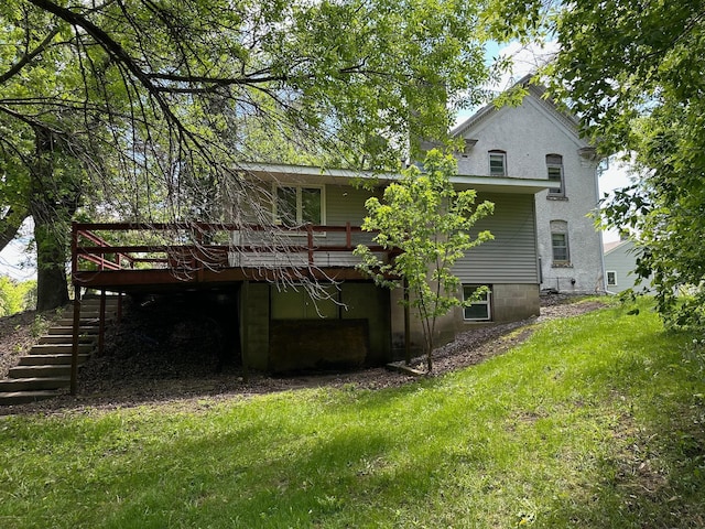 6950 270th St, New Prague, MN 56071 - rear view of house featuring stairway, a wooden deck, a garage, and a yard