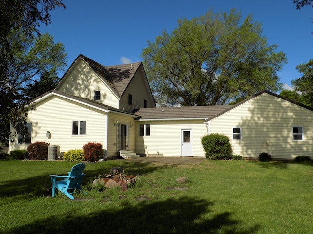 534 200th St, Cedar Twp, MN 56176 - back of house with entry steps, a lawn, and central AC