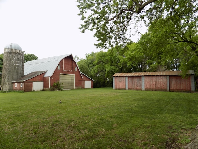 534 200th St, Cedar Twp, MN 56176 - view of green lawn with a barn, a detached garage, and an outbuilding