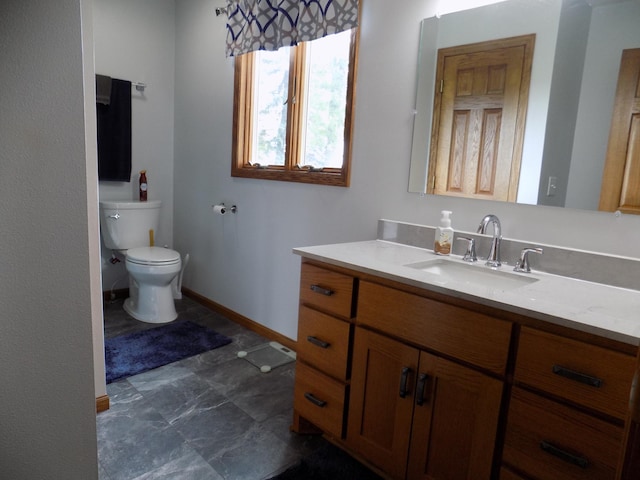 534 200th St, Cedar Twp, MN 56176 - bathroom with vanity, toilet, and baseboards