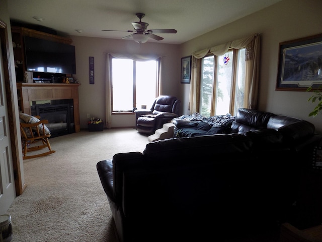 534 200th St, Cedar Twp, MN 56176 - carpeted living area featuring ceiling fan and a glass covered fireplace