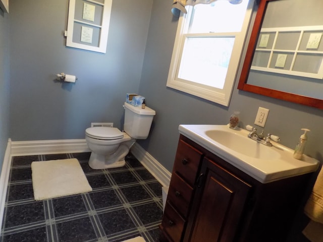 534 200th St, Cedar Twp, MN 56176 - bathroom featuring vanity, toilet, baseboards, and tile patterned floors