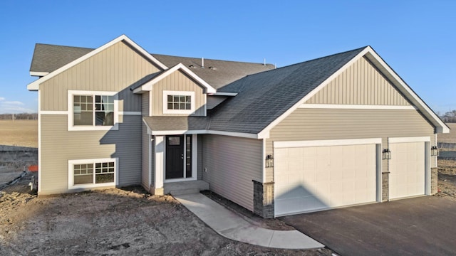2701 213th St W, Farmington, MN 55024 - view of front of property with an attached garage, board and batten siding, a shingled roof, and asphalt driveway