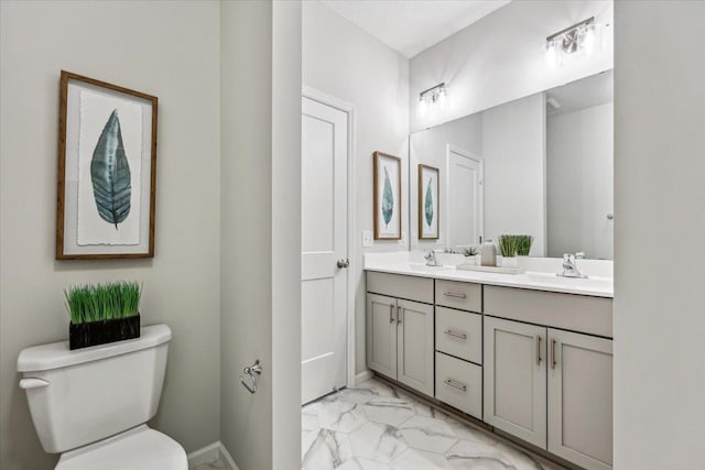 2701 213th St W, Farmington, MN 55024 - full bathroom featuring marble look tiles, double vanity, toilet, and baseboards