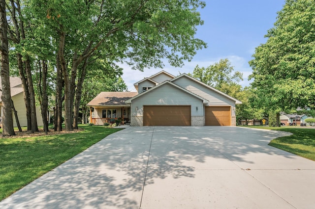 15144 Zilla St NW, Andover, MN 55304 - view of front of house featuring concrete driveway, covered porch, an attached garage, a front yard, and brick siding