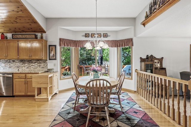 15144 Zilla St NW, Andover, MN 55304 - dining space featuring light wood-style flooring, a chandelier, baseboards, and a fireplace