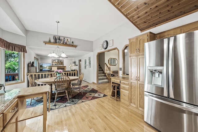 15144 Zilla St NW, Andover, MN 55304 - dining area featuring light wood finished floors, stairway, a chandelier, and arched walkways