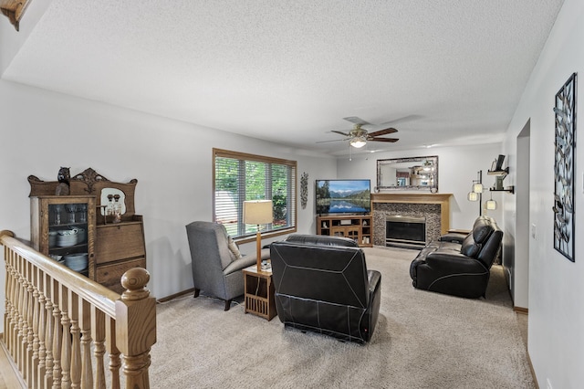 15144 Zilla St NW, Andover, MN 55304 - living area featuring light colored carpet, a textured ceiling, a ceiling fan, a high end fireplace, and baseboards