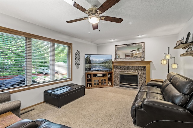 15144 Zilla St NW, Andover, MN 55304 - living room featuring carpet, a ceiling fan, a textured ceiling, a fireplace, and baseboards