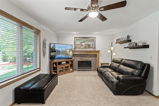 15144 Zilla St NW, Andover, MN 55304 - carpeted living area with ceiling fan, a tiled fireplace, and baseboards