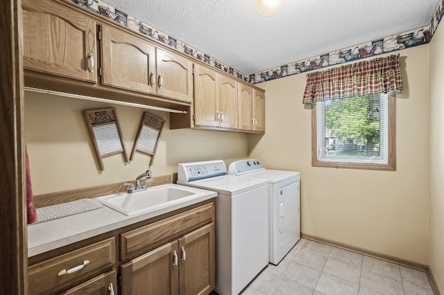 15144 Zilla St NW, Andover, MN 55304 - washroom with cabinet space, separate washer and dryer, a textured ceiling, baseboards, and light tile patterned flooring
