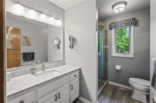 15144 Zilla St NW, Andover, MN 55304 - full bath with toilet, vanity, a stall shower, wood finished floors, and baseboards