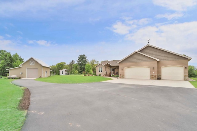 23369 330th St, Sebeka, MN 56477 - ranch-style house featuring stone siding, a front yard, asphalt driveway, an outdoor structure, and an attached garage
